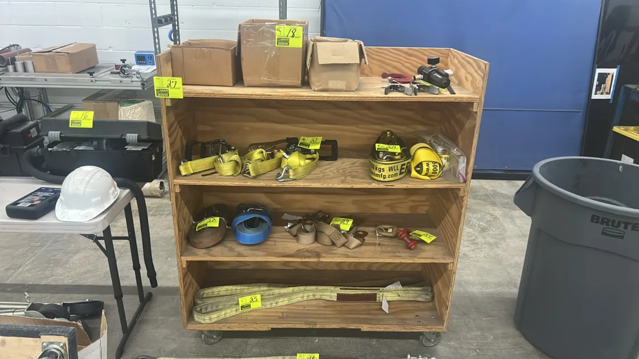 Wooden multi-tier portable rack. Features 4-shelf plywood construction. 48"L x 20"W x 54"H. Mounted on casters. Contents not included.