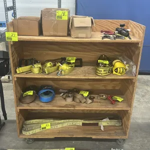 Wooden multi-tier portable rack. Features 4-shelf plywood construction. 48"L x 20"W x 54"H. Mounted on casters. Contents not included.