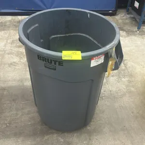 Rubbermaid Brute polyethylene trash bin. Features integrated side handles and molded venting channels. Gray plastic construction. Contents not include