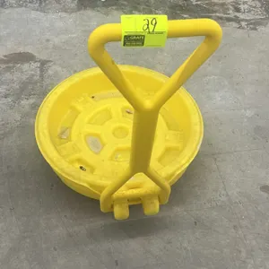 Polyethylene mobile drum spill dolly. Features molded yellow poly construction, containment sump basin, integrated handle, and swivel casters.