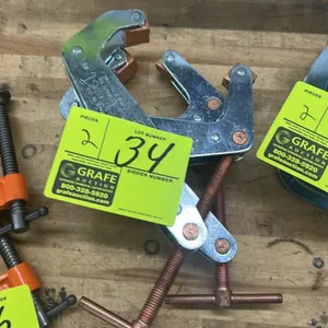 Kant-Twist cantilever T-clamps. Features T-handle drive screws, copper-plated spindle hardware, and swiveling jaw pads.