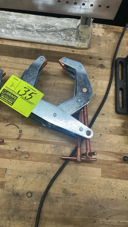 Kant-Twist cantilever T-handle clamps. Features zinc-plated steel frames, copper-plated threaded spindles, and swivel jaw pads.