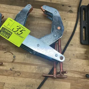 Kant-Twist cantilever T-handle clamps. Features zinc-plated steel frames, copper-plated threaded spindles, and swivel jaw pads.
