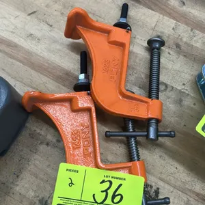 Pony 1623 hold-down clamps. Features cast iron construction with orange finish, threaded steel drive screws with sliding pin handles, and bench mounti