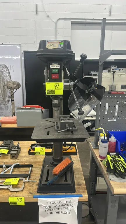 Jet JDP-15M benchtop drill press. Features clear chuck guard, mounted Palmgren drill press vise, slotted adjustable worktable with crank elevation, an