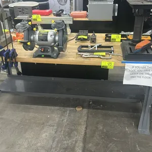 Metal 2-tier work bench. Features a wood top and lower metal storage shelf. 6'L x 3'W. Contents not included.