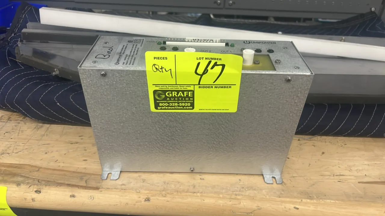 Unipower 229-00053-10000 AC power supply with assorted metal pieces and panel components. S/N: 3121-DG130. Electrical: +24VDC, 2A input; dual 8-15kV p