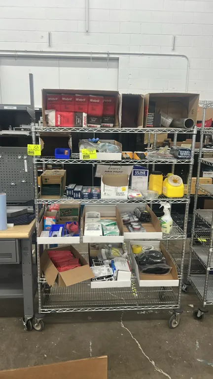 Assorted safety and shop maintenance supplies. Includes Webril Handi-Pads, Uvex safety glasses, Uline respirator masks, 3M filter cartridges, Scotch-B