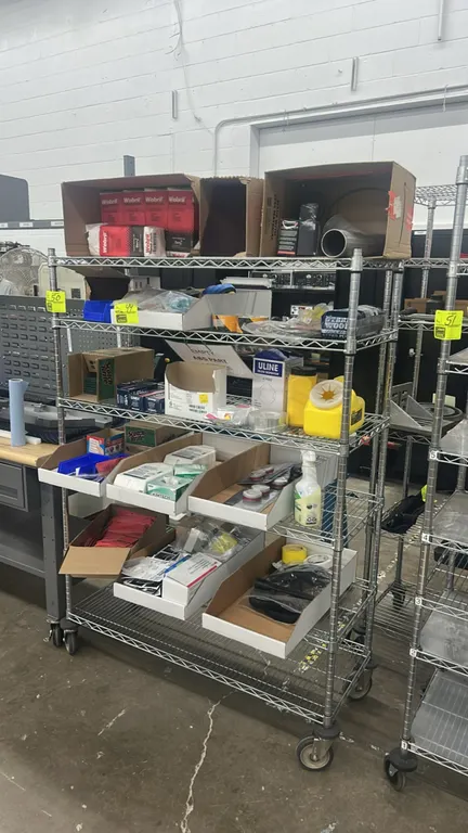 Multi-tier portable wire shelving rack. Features 5 wire shelves with a chrome finish. 48" x 20". Mounted on swivel casters. Contents not included.