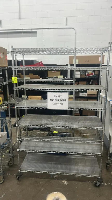 Metal multi-tier portable wire shelving rack. Features 7 adjustable wire shelves with shelf liners. 48" x 18". Mounted on swivel casters with protecti
