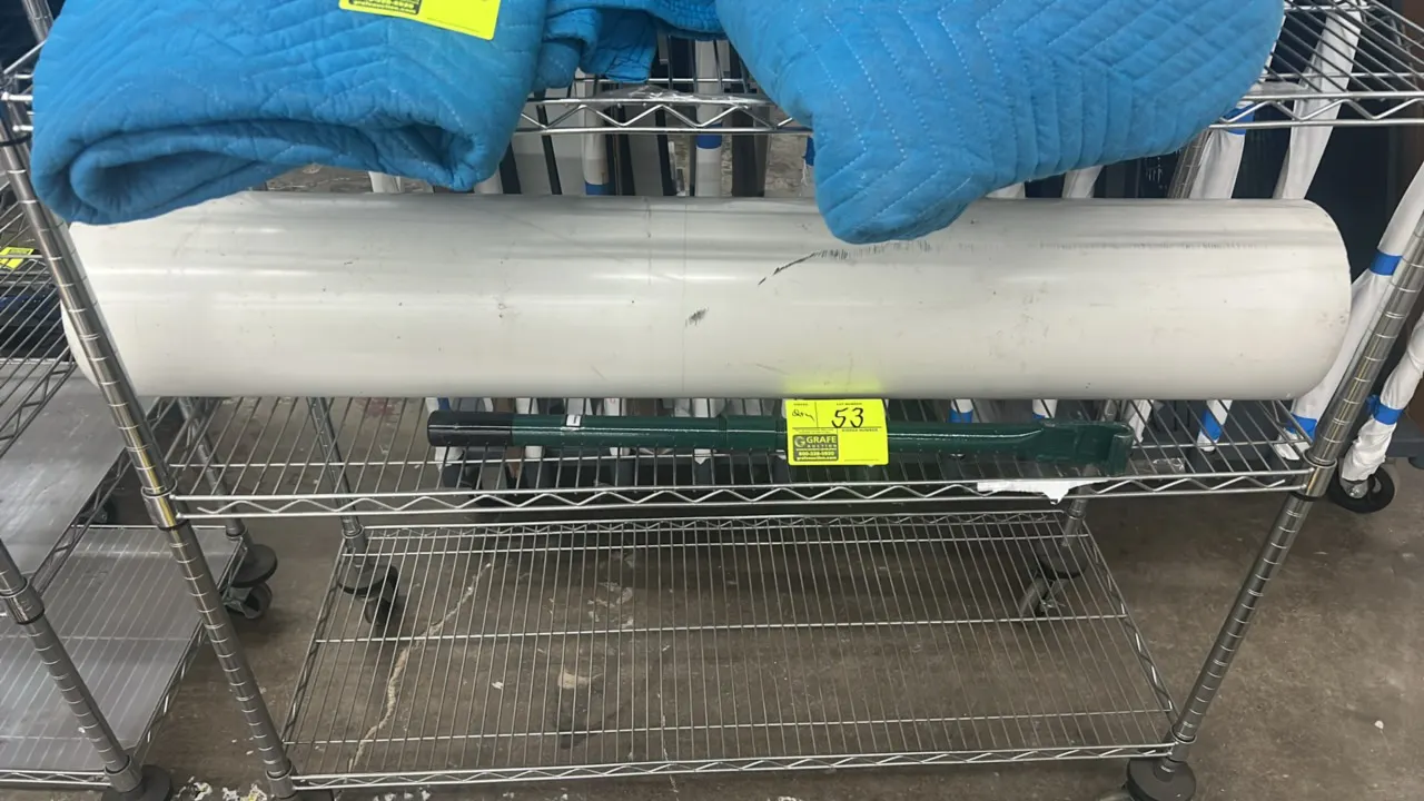 Steel U-post and 8" PVC pipe lot. Includes a green-painted steel U-post and a section of 8" diameter white PVC pipe. Wire shelving cart and moving bla