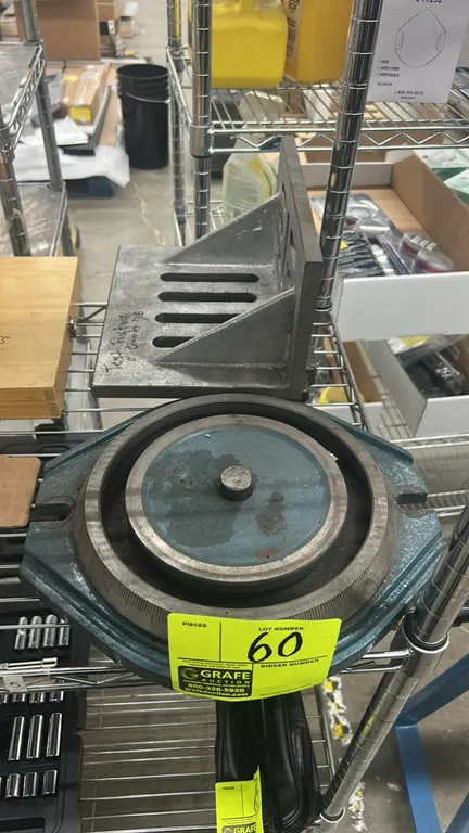 Machinist tooling lot. Includes a cast-iron milling machine vise swivel base and a webbed slotted angle plate. Swivel base features 360-degree graduat