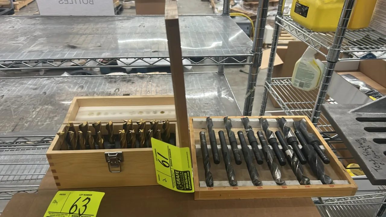 Assorted tooling bit sets. Includes (1) wooden index case of TiN-coated 2-flute and 4-flute end mills and (1) wooden case of Silver & Deming reduced-s