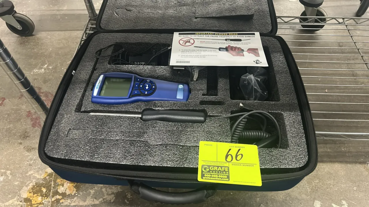 TSI VelociCalc multi-function ventilation meter. Includes handheld meter, telescoping probe with coiled cable, AC power adapter, and fitted carrying c