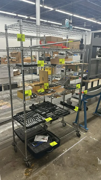 Metal multi-tier portable wire shelving rack. Features 5 adjustable wire shelves. 48" x 18". Mounted on swivel casters. Contents not included.