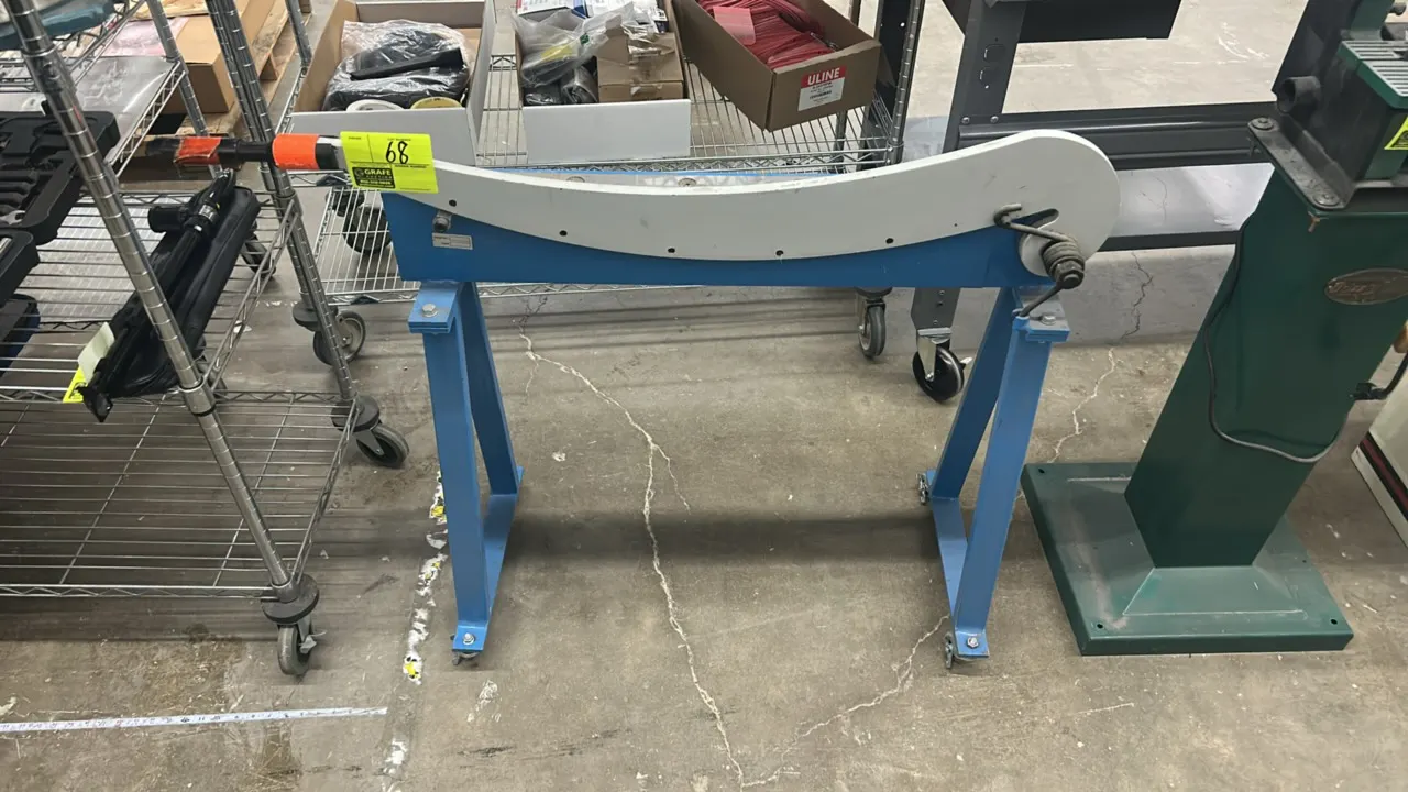 36" manual plate shear sheet metal cutter. Features spring-assisted curved cutting blade. Mounted on a steel stand with casters.