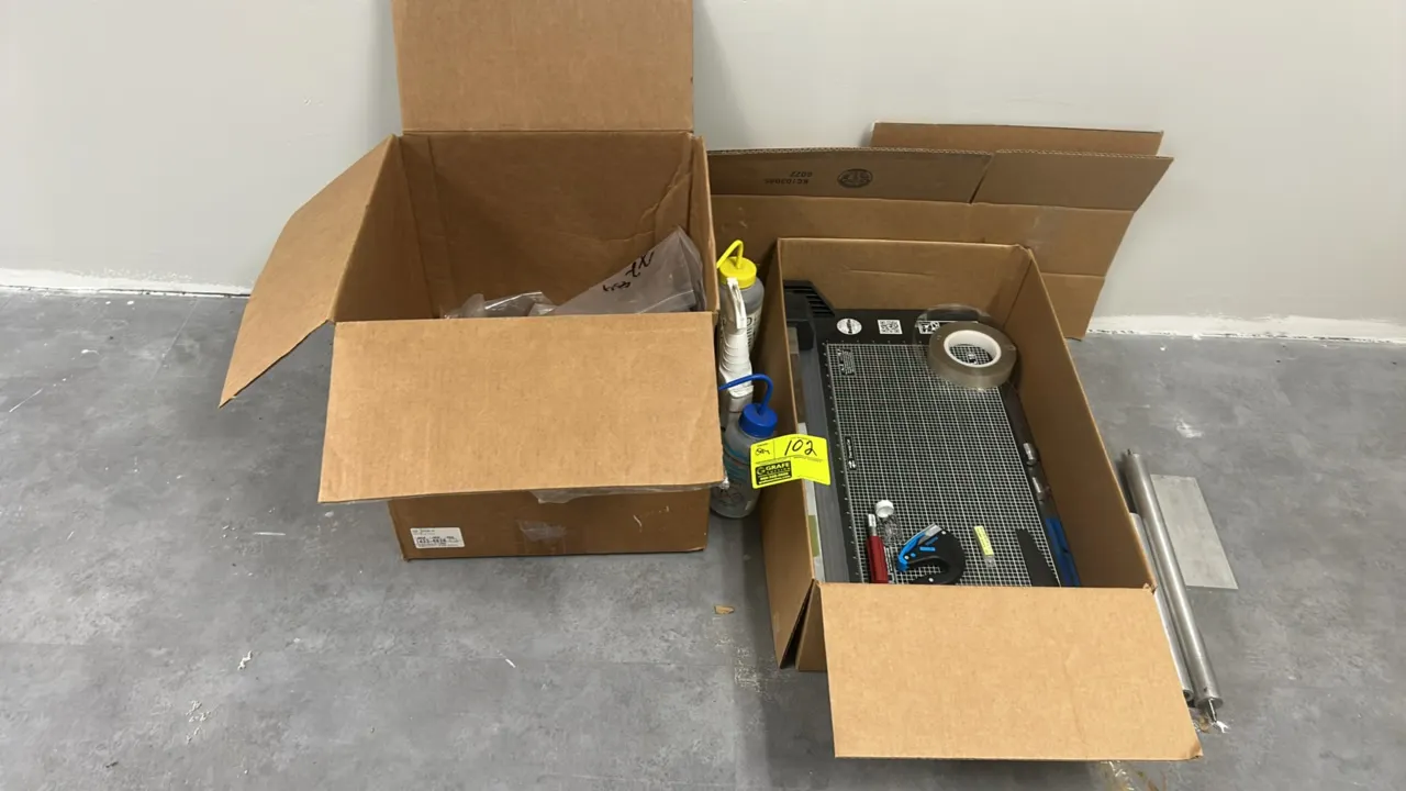 Rotatrim rotary paper trimmer with assorted cords and remaining box contents. Includes rotary paper trimmer with grid cutting board, Martor safety cut
