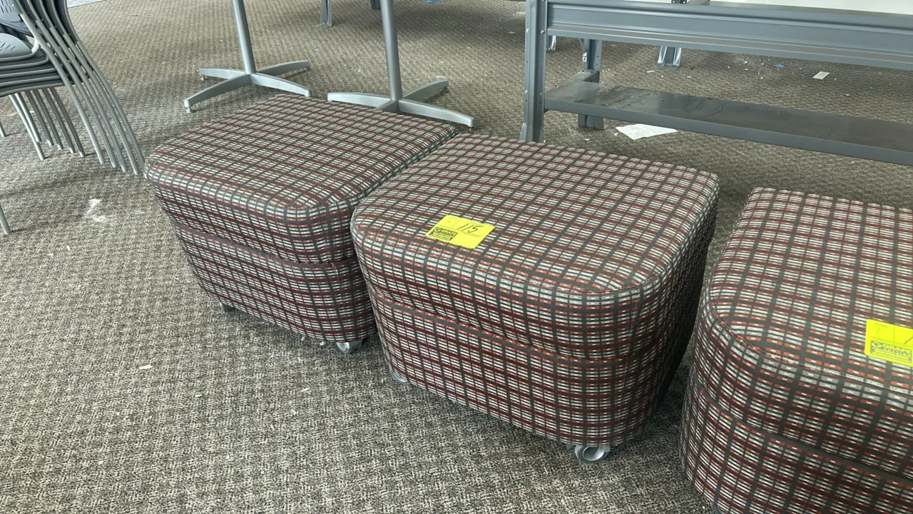 Cushioned rolling ottomans. Features multi-color patterned fabric upholstery and padded tops. Mounted on casters.