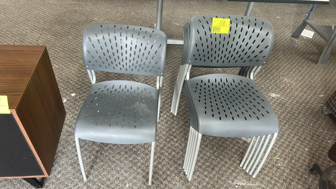 Poly stacking chairs. Features gray perforated polypropylene seats and backrests. Mounted on silver-tone metal 4-leg frames.