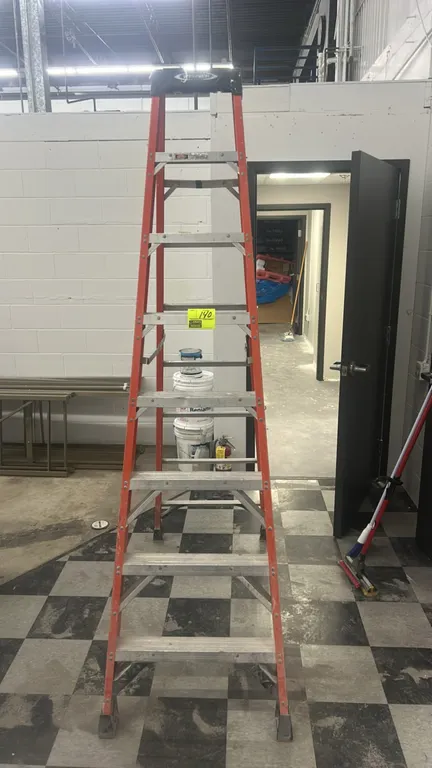 Werner 8' fiberglass step ladder. Features orange non-conductive fiberglass side rails, aluminum slip-resistant steps, steel spreader braces, and a mo