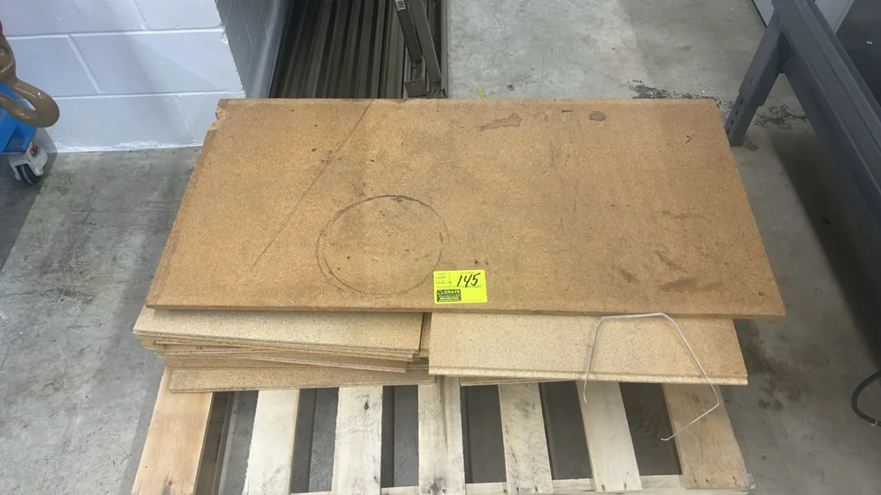 Stack of medium-density fiberboard panels. Stored on a wooden shipping pallet.