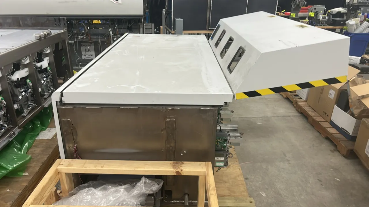 Kodak NexPress SX3300 digital production color press. Main print engine unit mounted on a wooden pallet base. Features hinged top access hood with ins