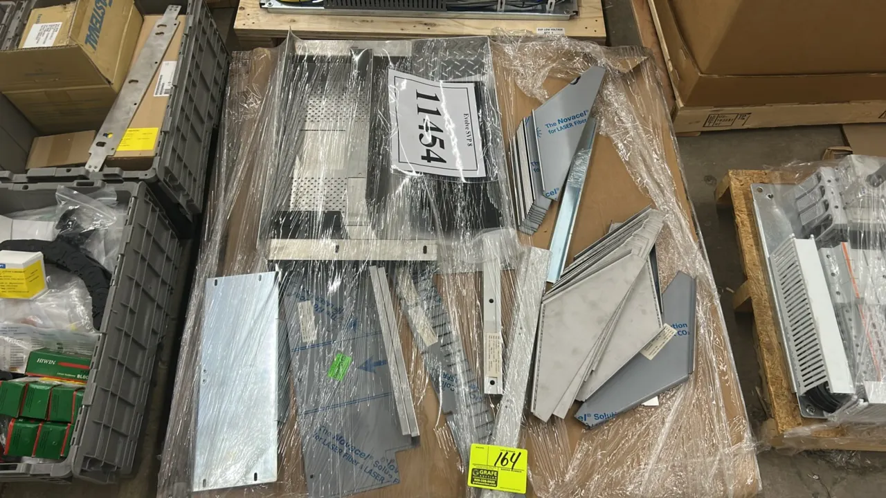 Assorted custom-cut sheet metal and fabricated metal parts. Includes laser-cut plates, formed brackets, gussets, perforated panels, and structural com