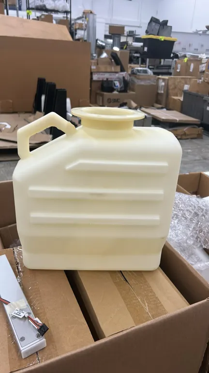 Assorted parts lot. Includes rectangular plastic carboy with integrated handle, metal rough-in mounting plate, Low Bay End-Of-Row motion sensor, and r