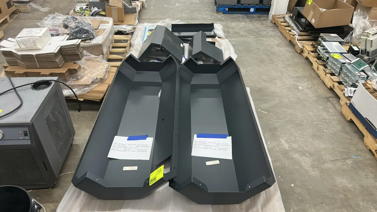Assorted sheet metal covers, panels, and mounting brackets. Features formed dark gray painted/powder-coated finish panels and a galvanized mounting pl
