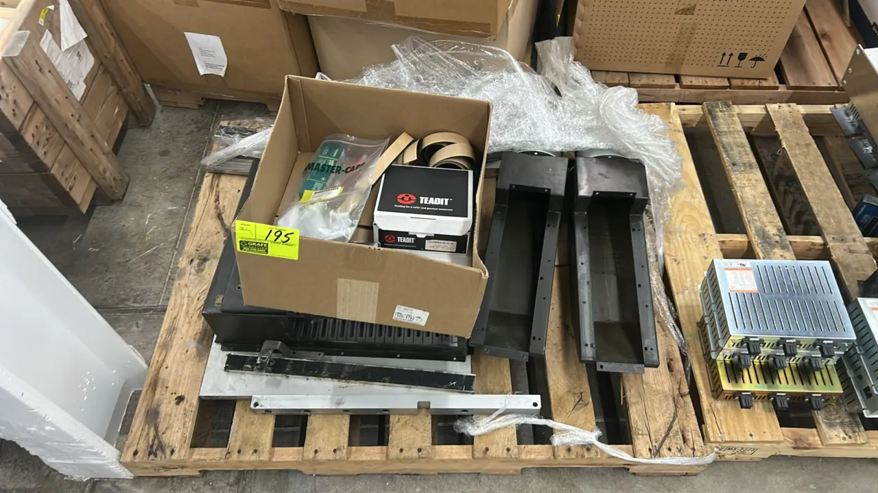 Industrial metal assembly with assorted components and supplies. Includes coated metal housings, duct and chute sections, linear rails, Teadit packing