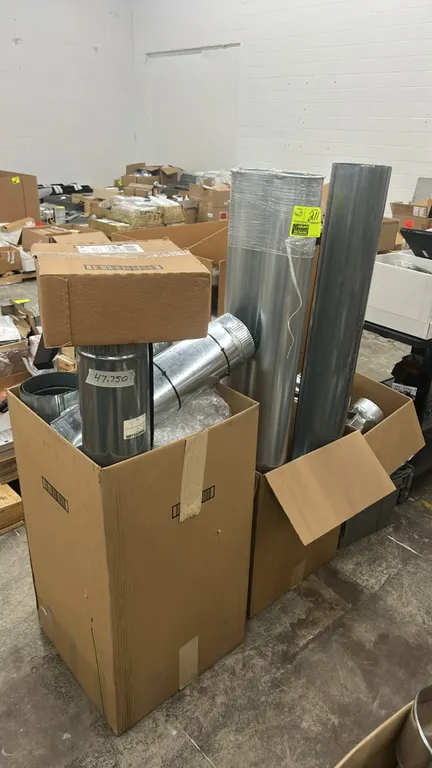 Assorted HVAC ductwork and fittings. Includes galvanized steel round duct pipes, register boots, transitions, and related components in various sizes.