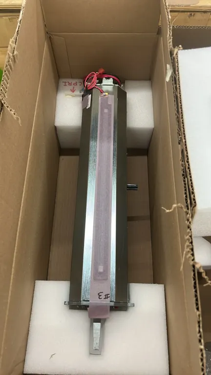 Industrial metal 3D printing components. Features linear metal housing assemblies, protective taped contact strips, and integrated wiring leads with t