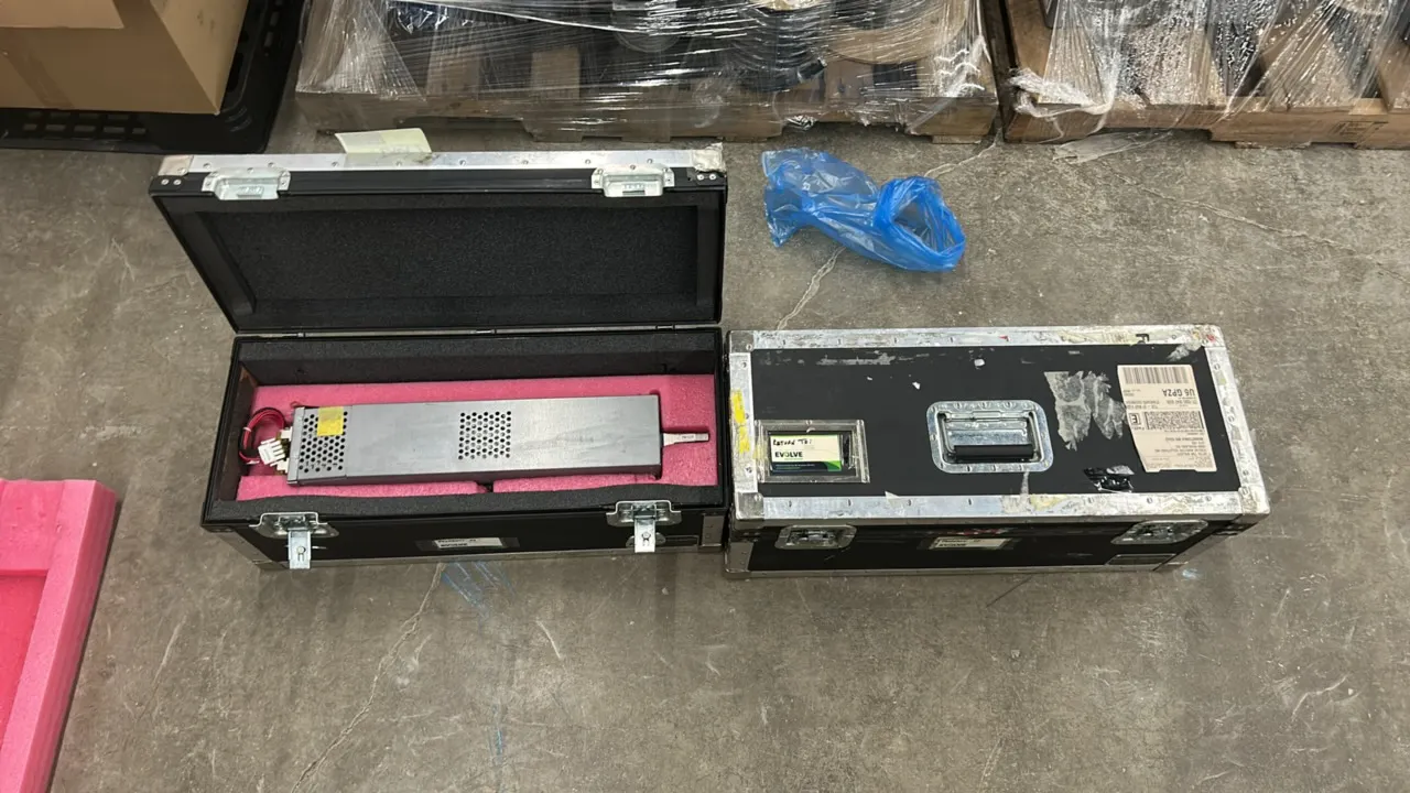 Network switch power supply modules. Includes custom foam-lined hard flight cases with latch closures and recessed carrying handles.