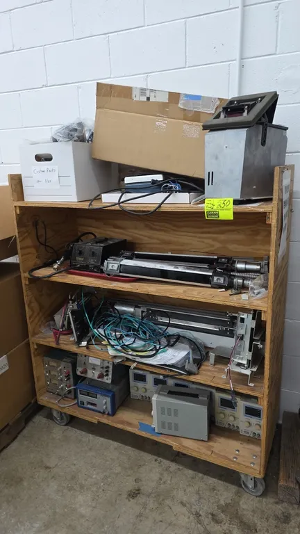 Portable wood shelving cart with assorted testing equipment and parts. Includes TekPower TP3005T DC power supplies, BK Precision 1671A power supply, P