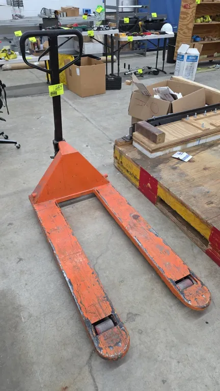 2011 L60 manual hand pallet jack. Features a 5,500 lbs capacity, manual pump handle with release lever, and polyurethane load wheels. Fork dimensions: