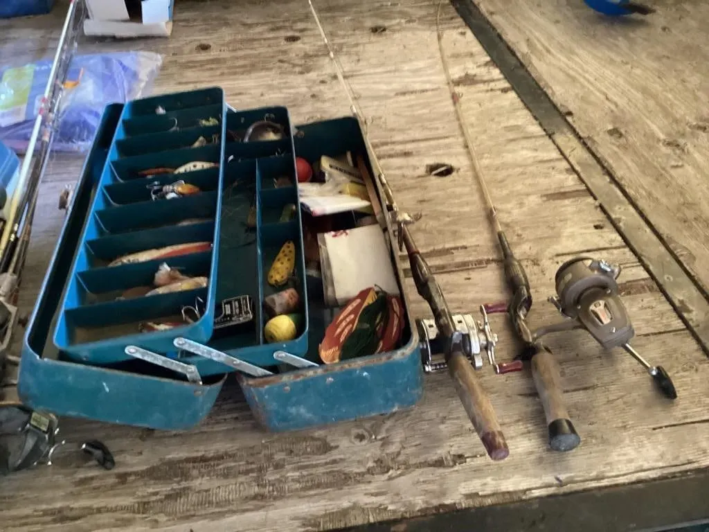 Steel tackle box full of tackle and 2 fishing