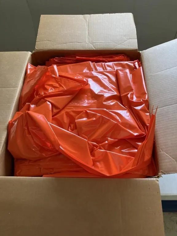 Full or nearly full case of orange trash bags.