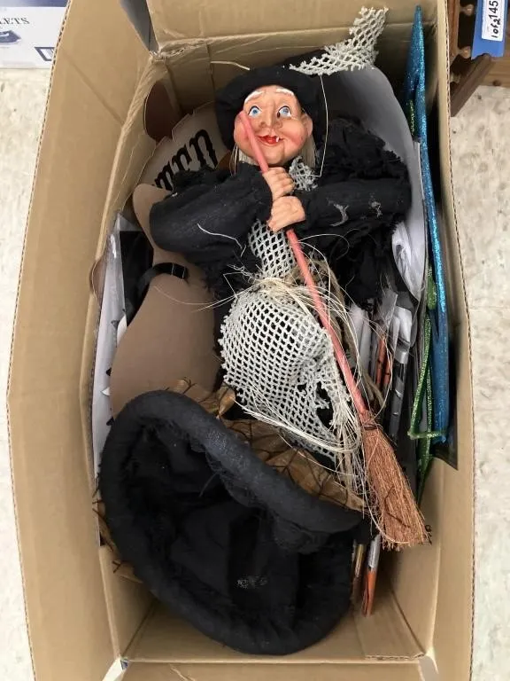 Box of Halloween decorations with witch.
