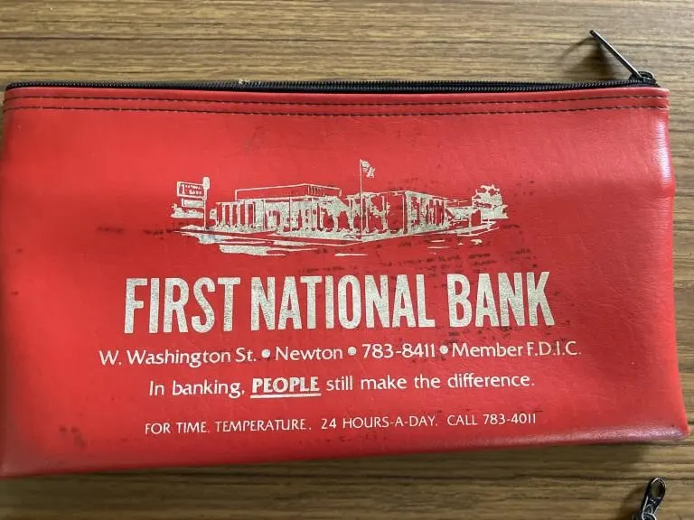 Three bank deposit bags. Two of the zippers are