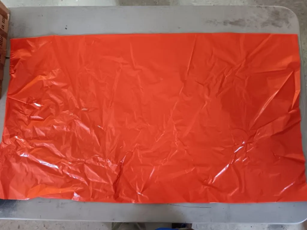 Box of unknown number of orange trash bags. 39in.