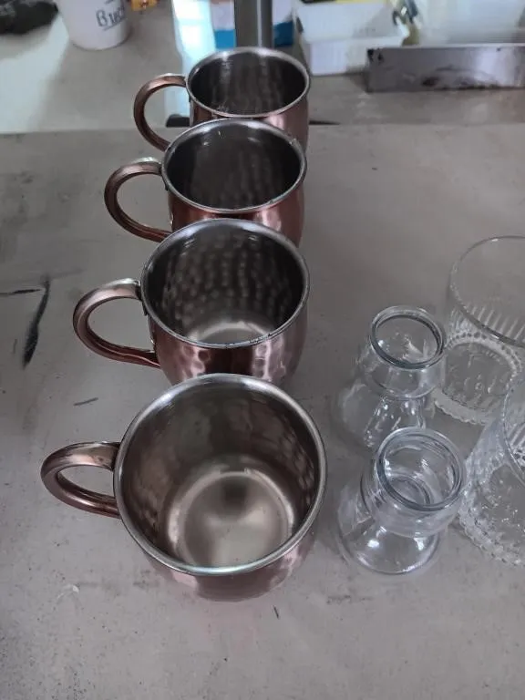 Assorted bar glasses, aluminum mugs, and shooter