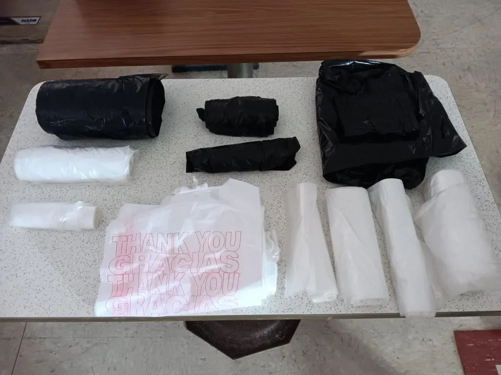 Assorted rolls of trash bags and carry out