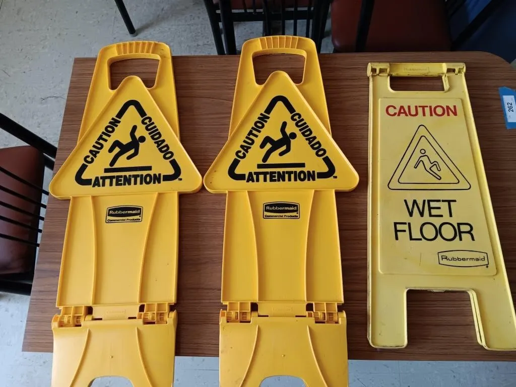 Three Rubbermaid Floor safety signs.
