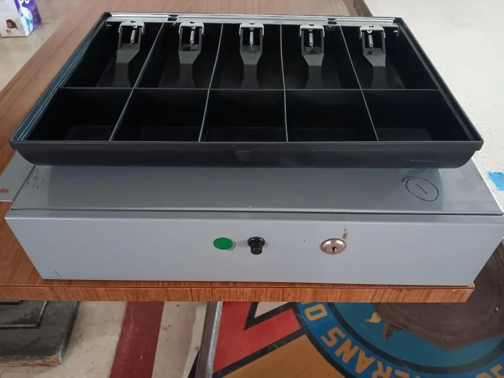 Cash drawer with mounting brackets.
(Opens and