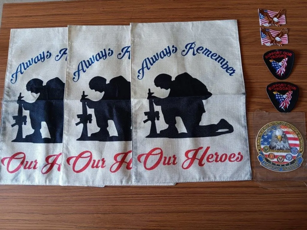 Three "Always Remember Our Heroes" garden flags.