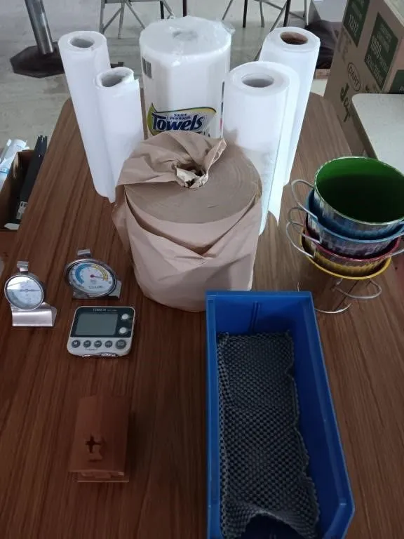 Assortment of paper towels, kitchen thermometer,