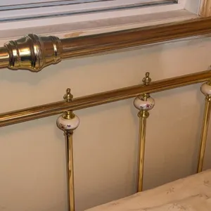Brass Bed Frame with Porcelain Floral Accents and Mattress