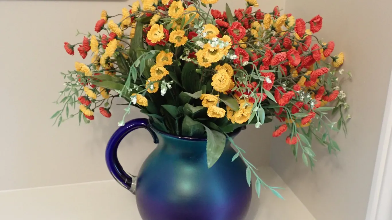 Art Glass Pitcher With Floral Arrangement