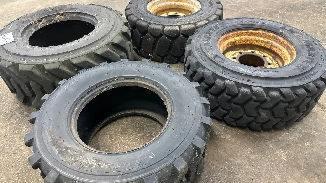 (2) Skid Steer Tires, (2) Skid Steer Tires W/ Rims