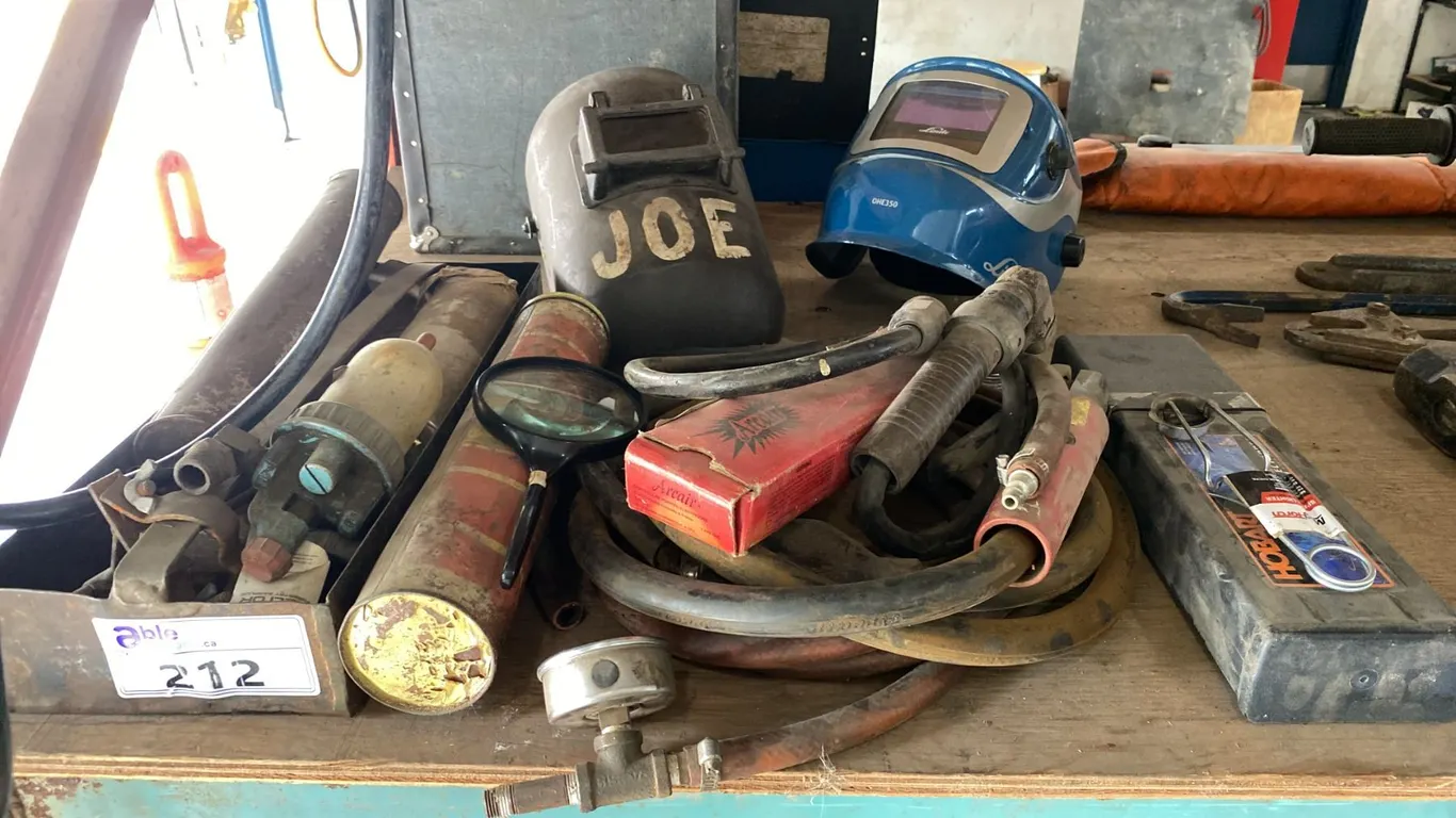 GROUP OF ASSORTED WELDING ITEMS- HELMETS, WELDING RODS, STICK GUNS & MORE
